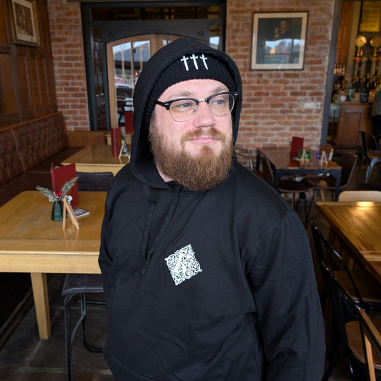 Man Wearing Kirkstall Logo Black Hoodie And Three Swords Beanie