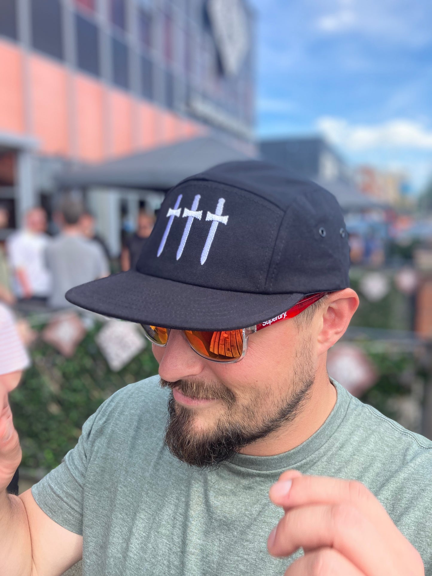 Man Wearing Three Swords Black Cap