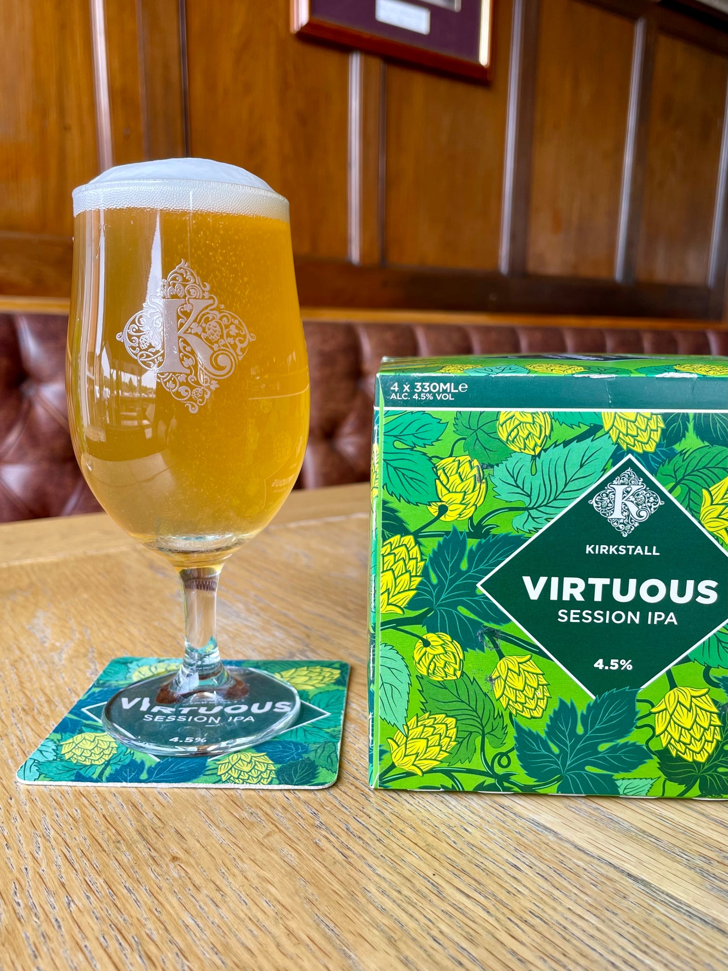 Half Pint Of Virtuous Next To 4 Pack Of 330ml Virtuous Cans On Table