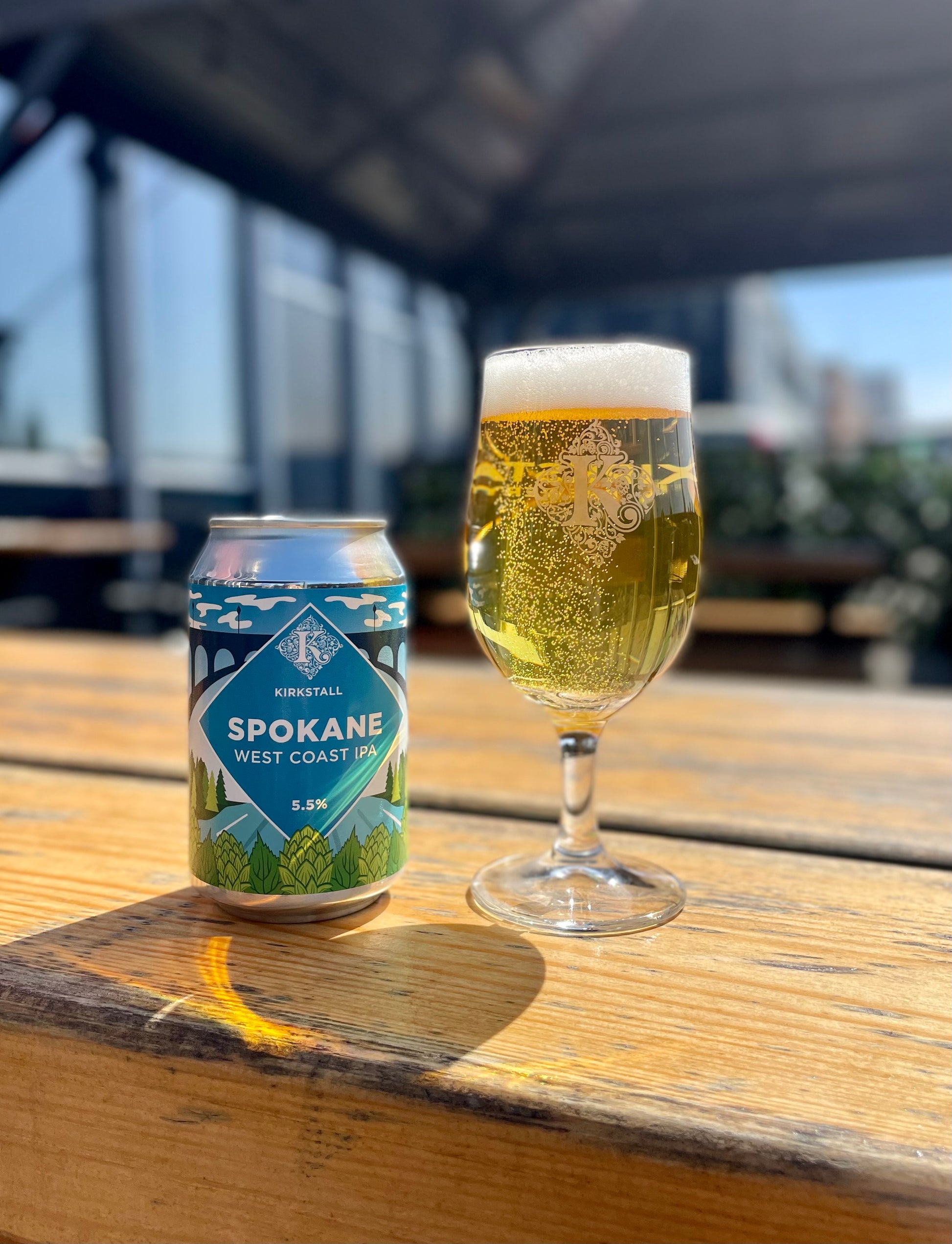 Spokane 330ml Can And Half Pint On Table Outside